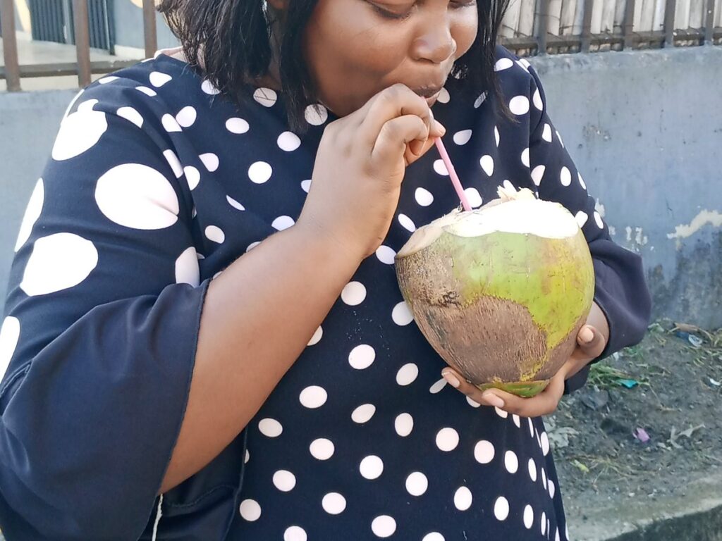 A lady drinking coconut water