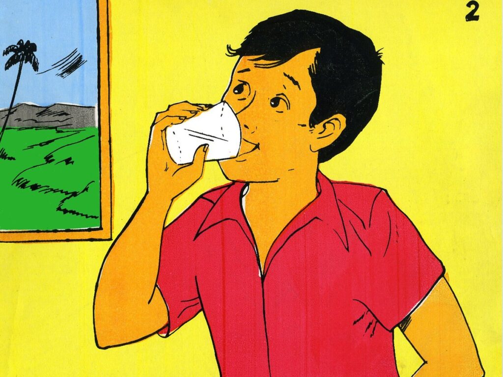 Boy drinking water in house